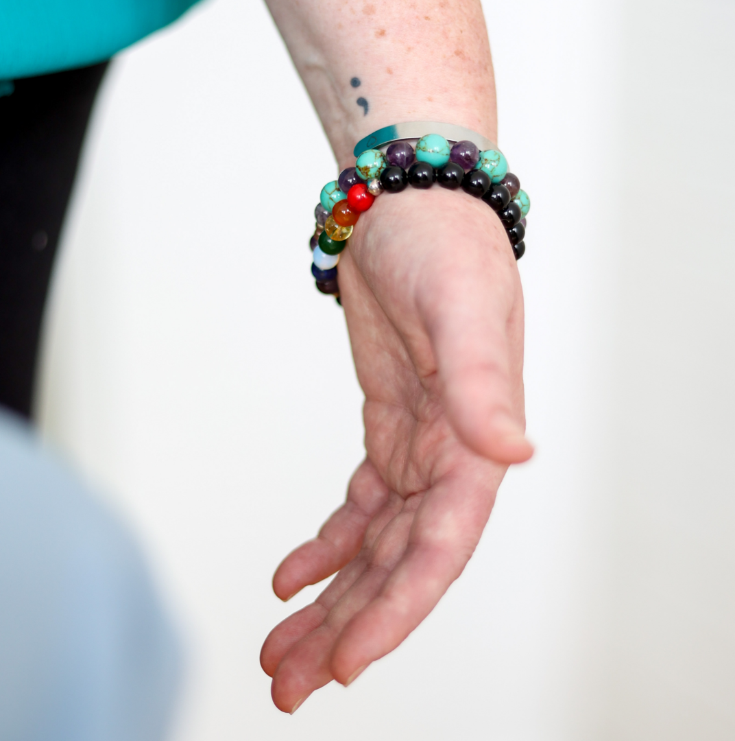 Hand with semicolon tattoo